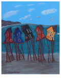 Colorful  Newfoundland fishing shacks on stilts with a blue sky and mountains in the background