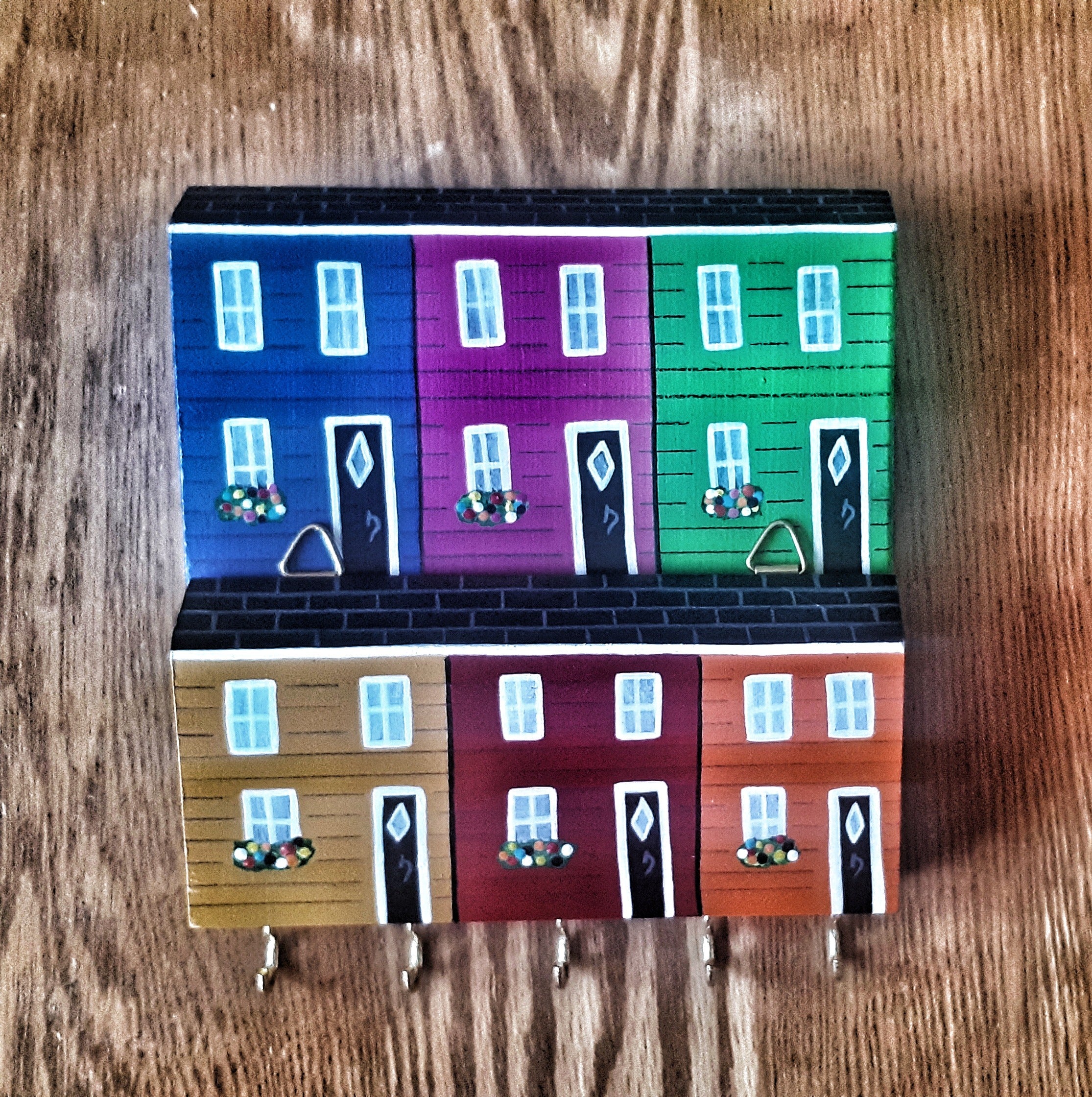  Key holder with Newfoundland Jelly Bean Rowhouses painted on a wooden surface