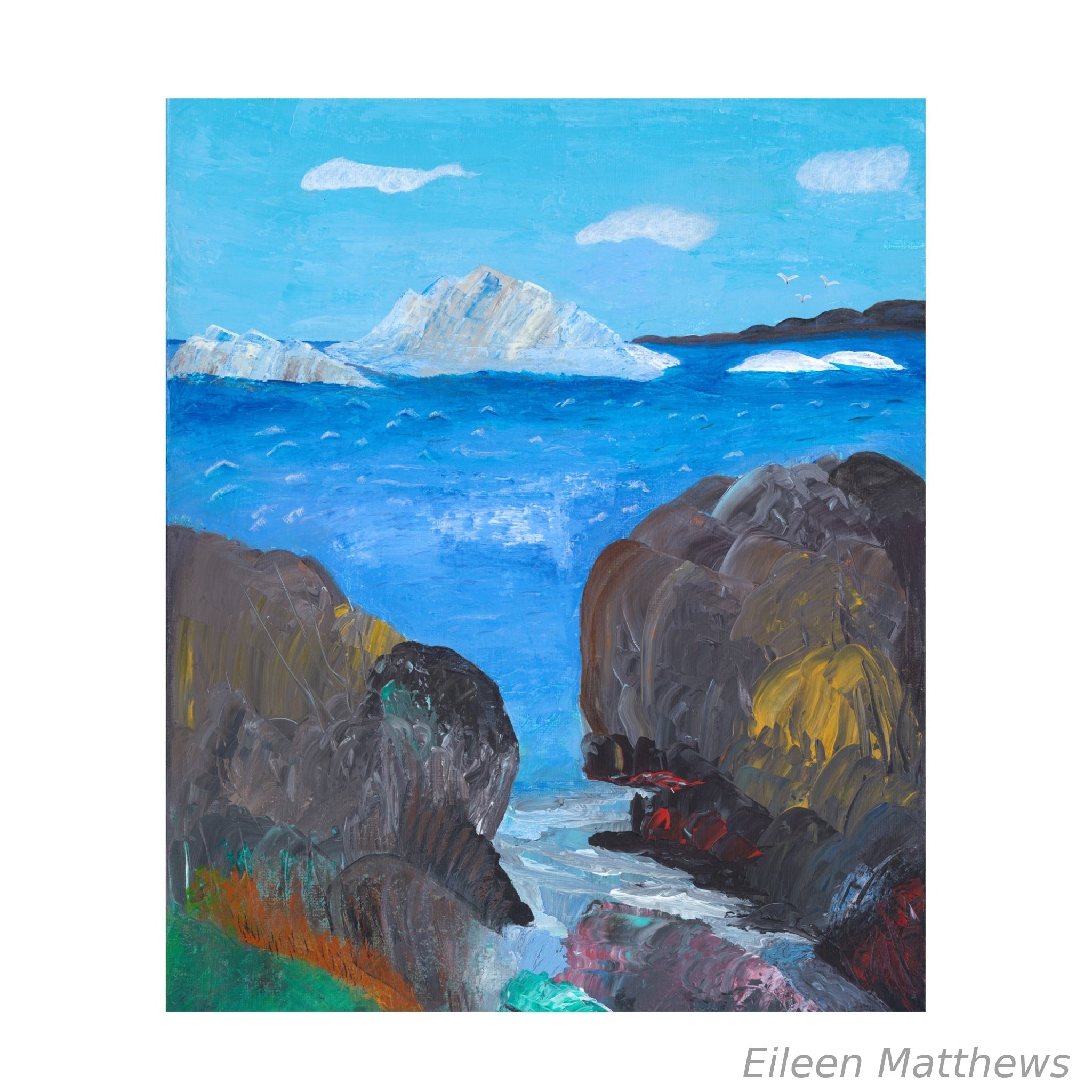 Rocks and cliffs in foreground with icebergs on the water in background which is what Newfoundland Spring is famour for - icebergs.