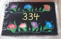 Slate sign with flowers and house number