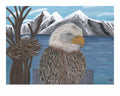 Eagle sitting on a post guarding its 2 chicks in a nest