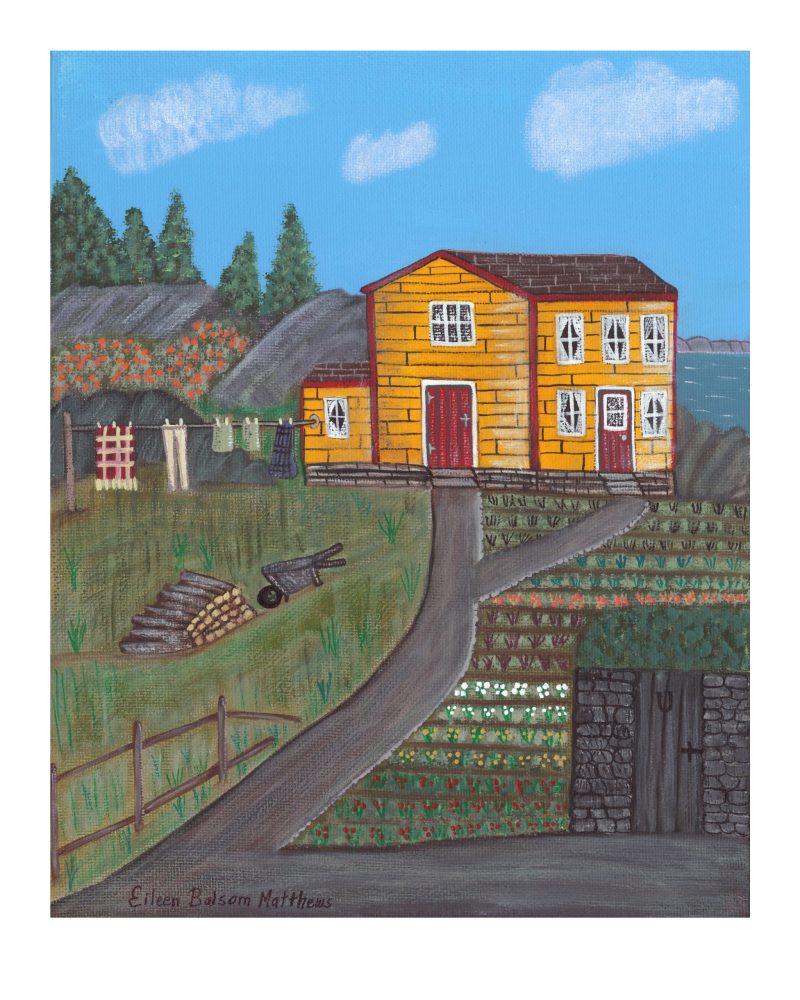 An old yellow house with a vegetable garden, walkway and water in the background.
